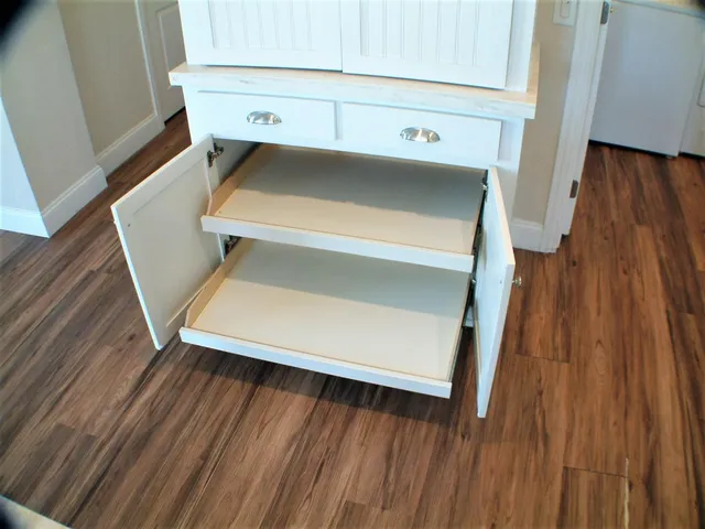 a utility room with wooden floor washer and dryer