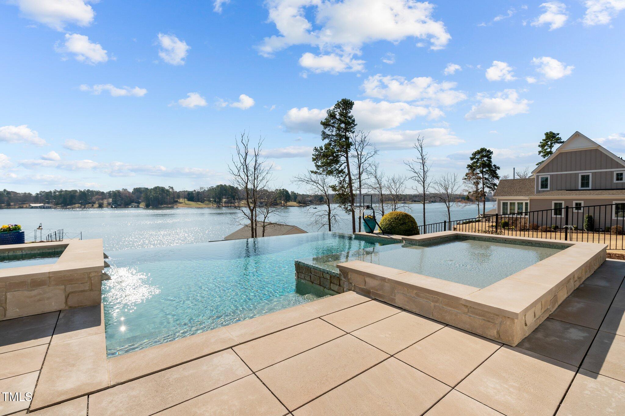 992 Estate Road Semora, NC 27343 - Photo 50 of 77 a view of a swimming pool with seating space and lake view
