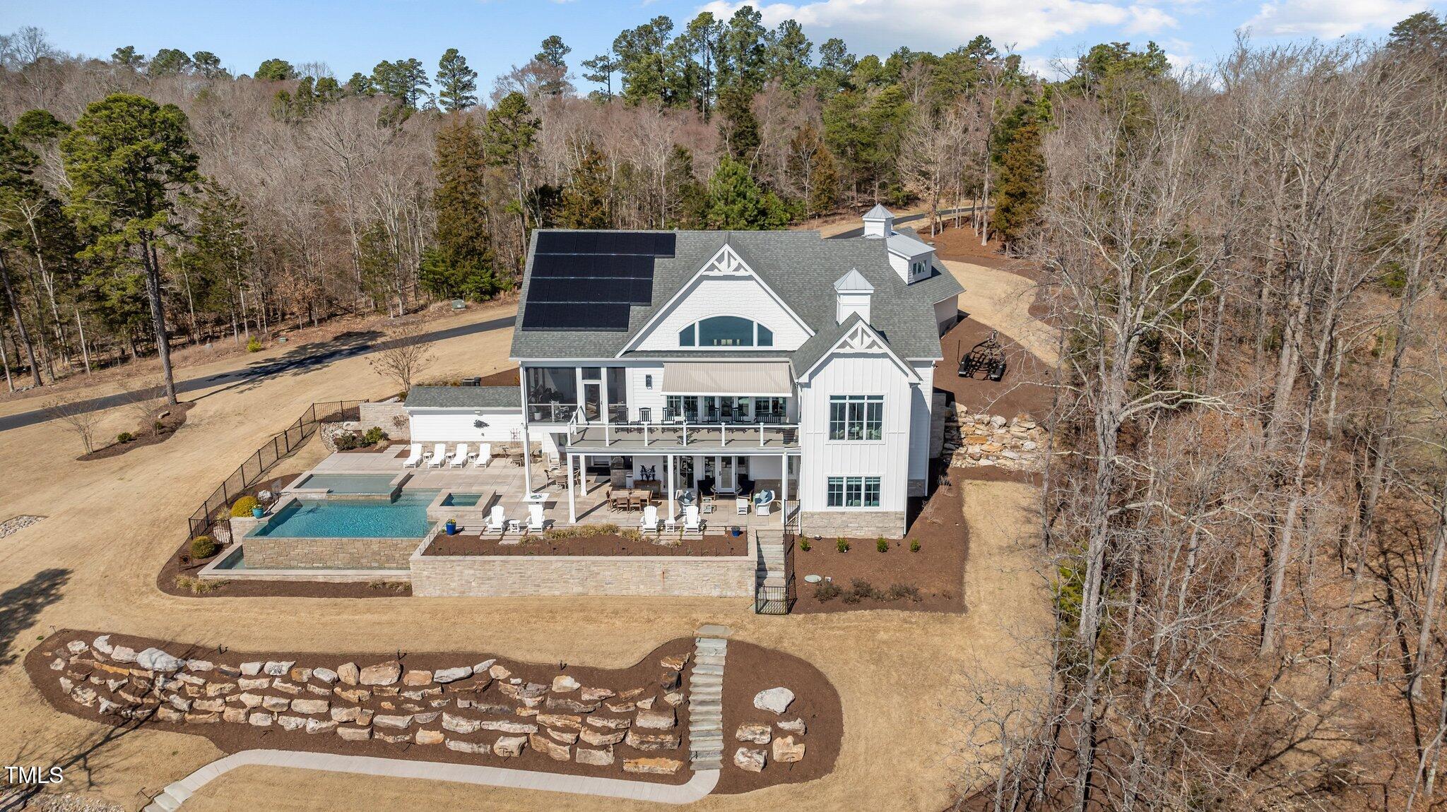 992 Estate Road Semora, NC 27343 - Photo 4 of 77 a view of a house with large trees and a couple of cars parked in front of it