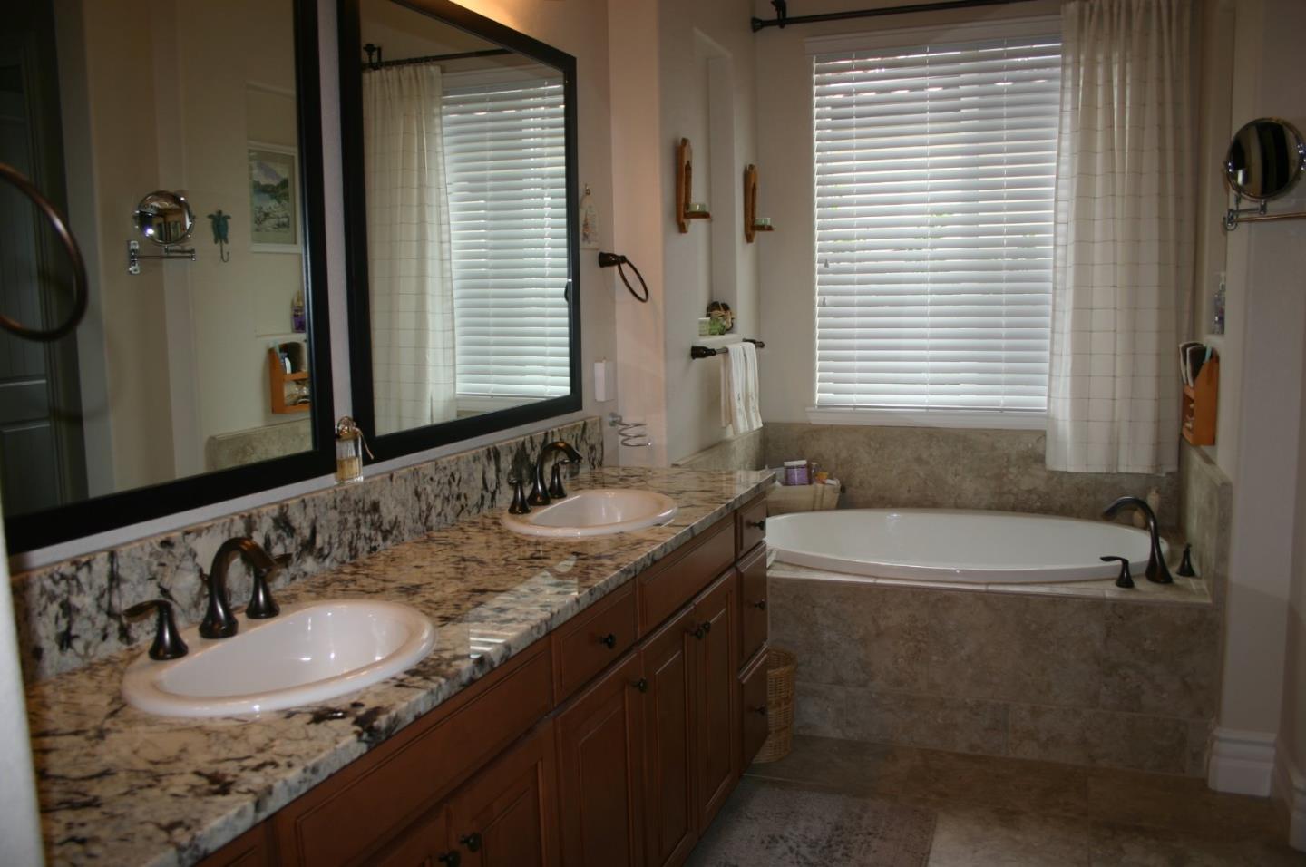7247 Pitlochry Drive Gilroy, CA 95020 - Photo 14 of 44 a bathroom with a granite countertop sink and a bathtub