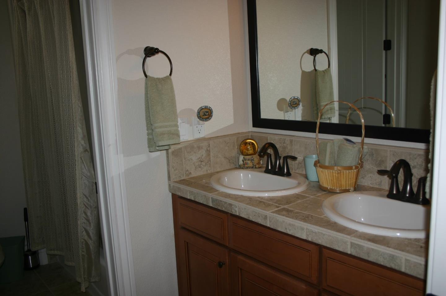 7247 Pitlochry Drive Gilroy, CA 95020 - Photo 21 of 44 a bathroom with double sink and a mirror