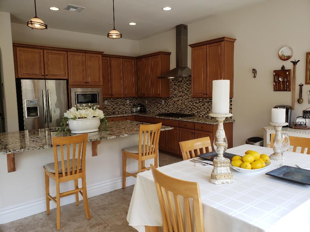7247 Pitlochry Drive Gilroy, CA 95020 - Photo 8 of 44 a kitchen with a sink a stove and chairs