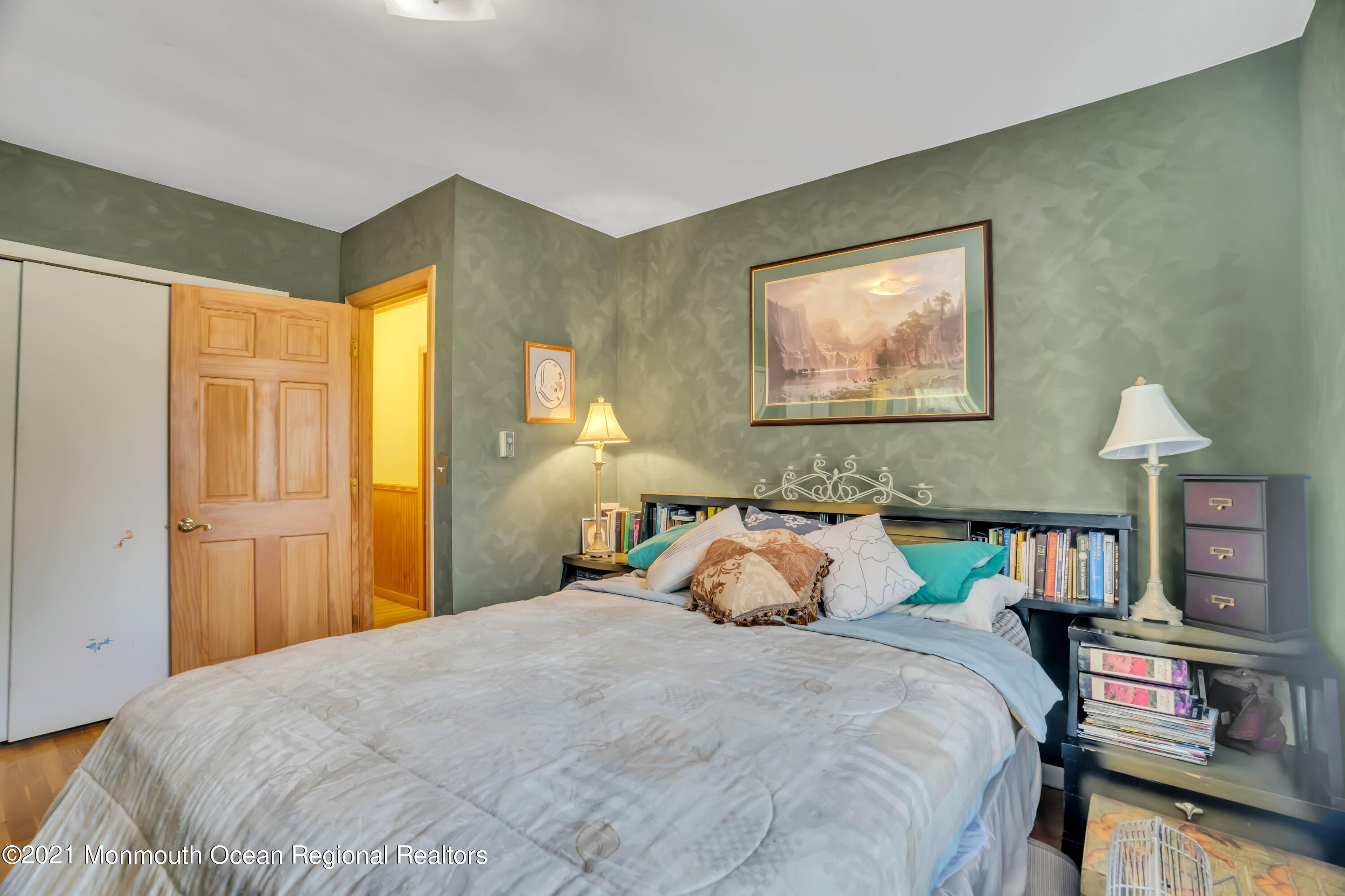 615 West Farms Road Howell, NJ 07731 - Photo 15 of 36 a bedroom with a bed and a chandelier