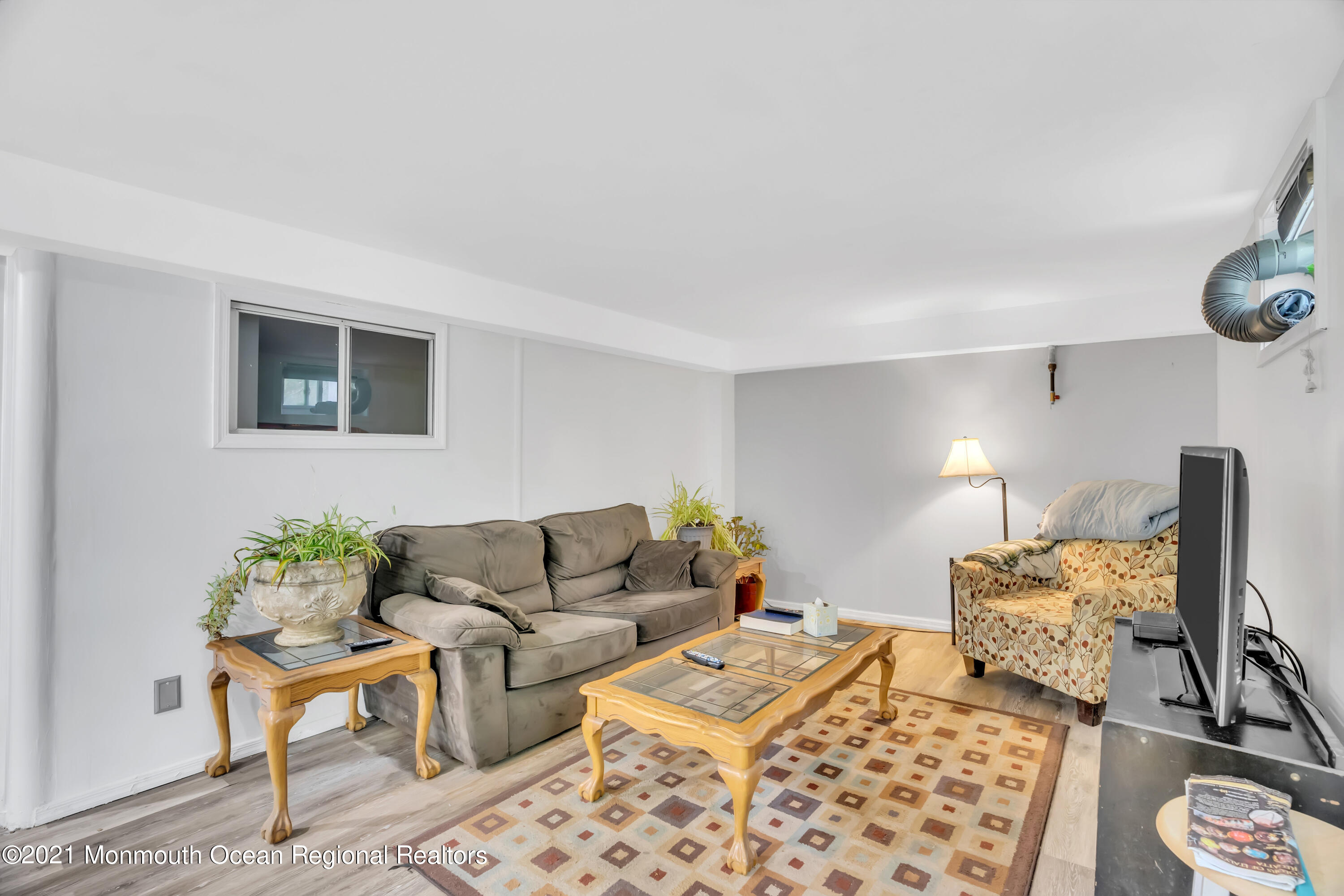 615 West Farms Road Howell, NJ 07731 - Photo 23 of 36 a living room with furniture and a lamp