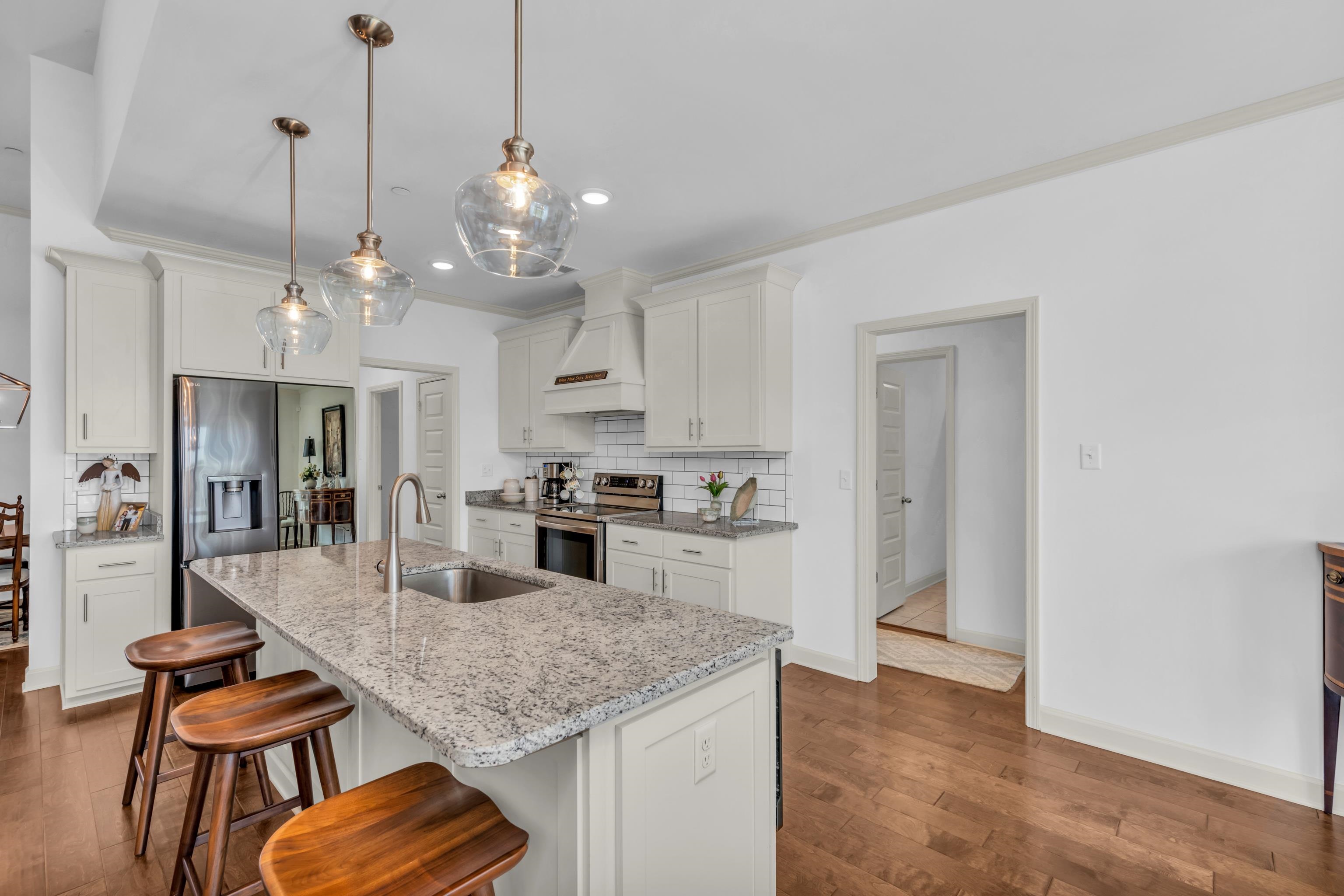 20 Thorpe Cove Piperton, TN 38017 - Photo 17 of 39 a kitchen with stainless steel appliances granite countertop a kitchen island a stove a table and chairs in it