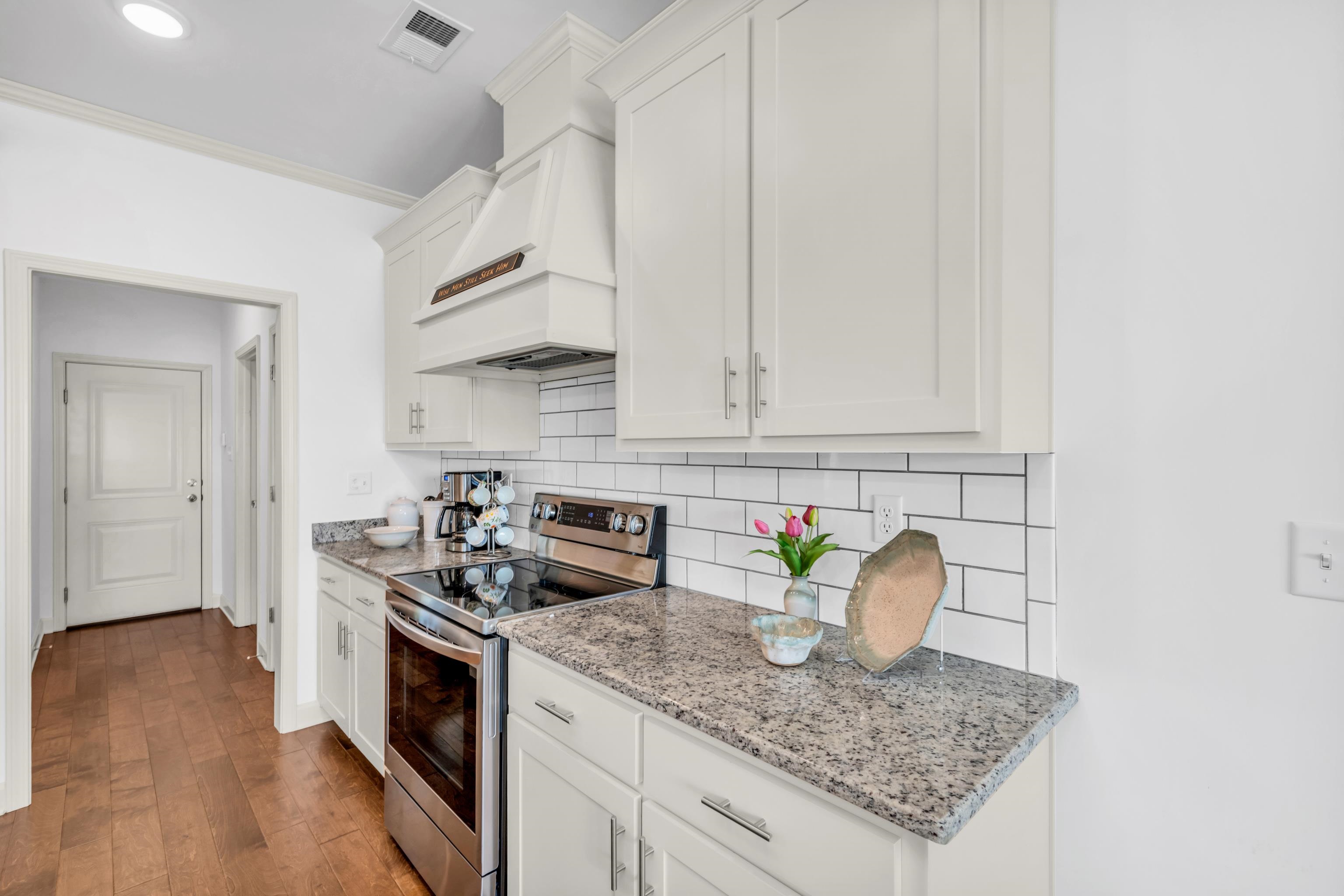 20 Thorpe Cove Piperton, TN 38017 - Photo 20 of 39 a kitchen with stainless steel appliances granite countertop a sink a stove and a wooden floors