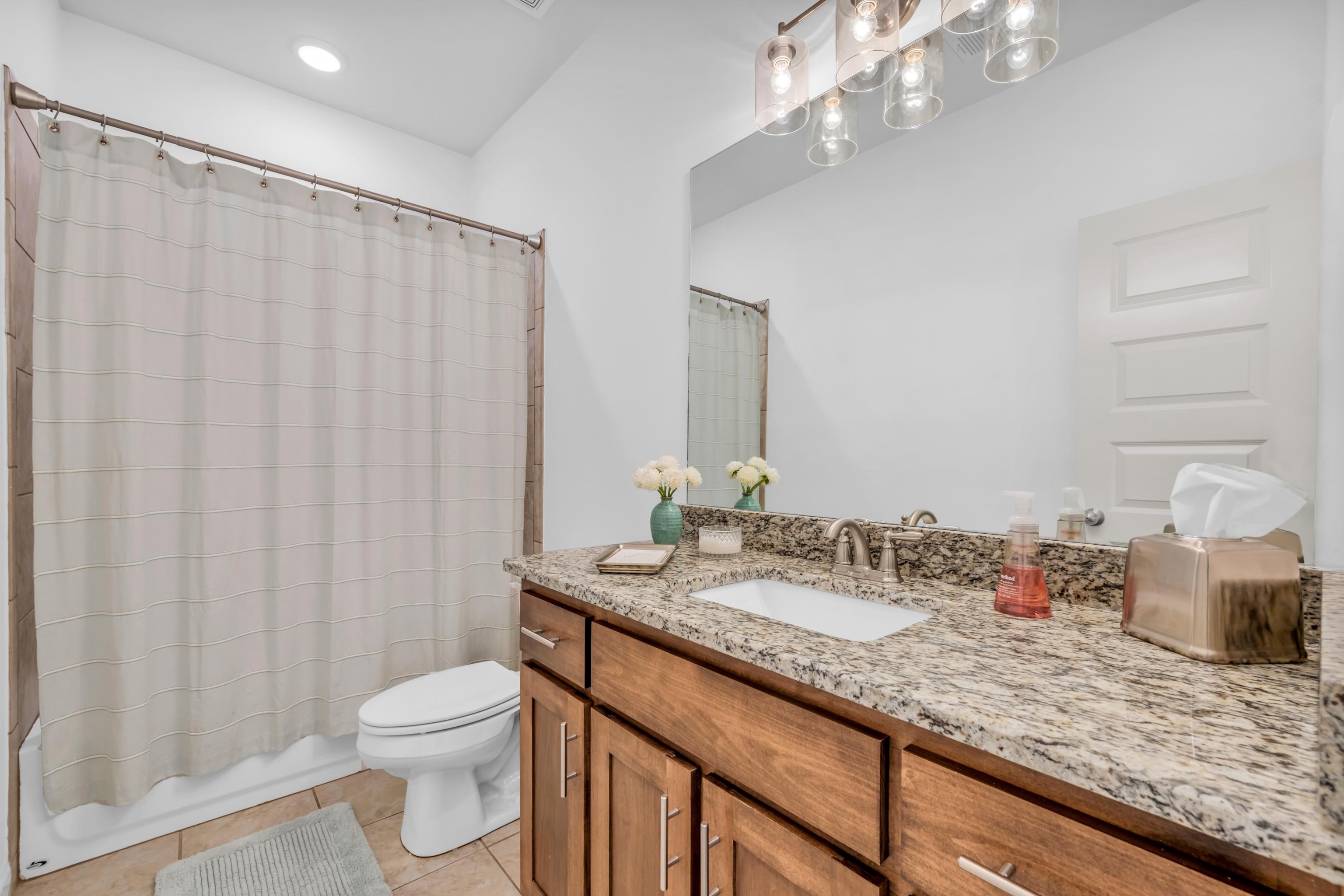 20 Thorpe Cove Piperton, TN 38017 - Photo 27 of 39 a bathroom with a granite countertop sink a toilet and a mirror