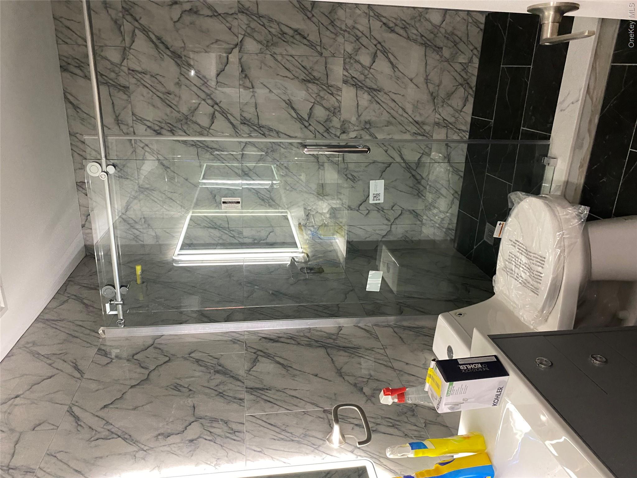 44 Roslyn Ridge Road Mongaup Valley, NY 12762 - Photo 22 of 24 Bathroom with tile walls, vanity, and a marble finish shower