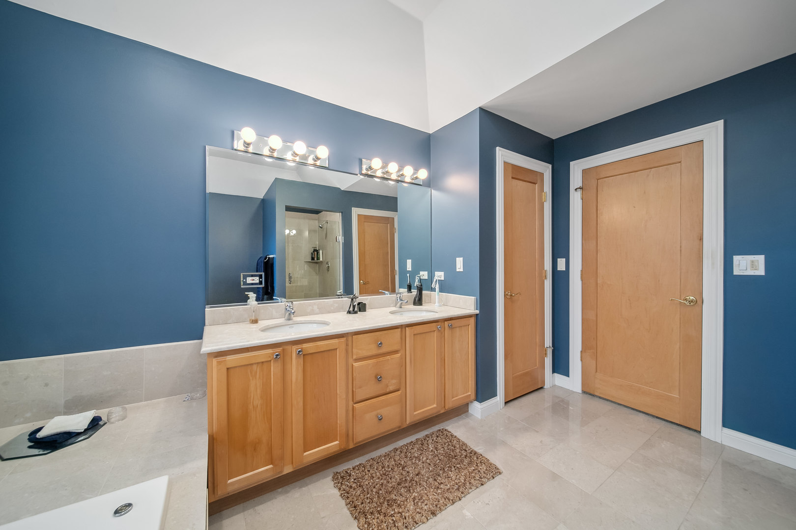 Undisclosed Address Park Ridge, IL 60068 - Photo 23 of 47 a large bathroom with a double vanity sink and a mirror