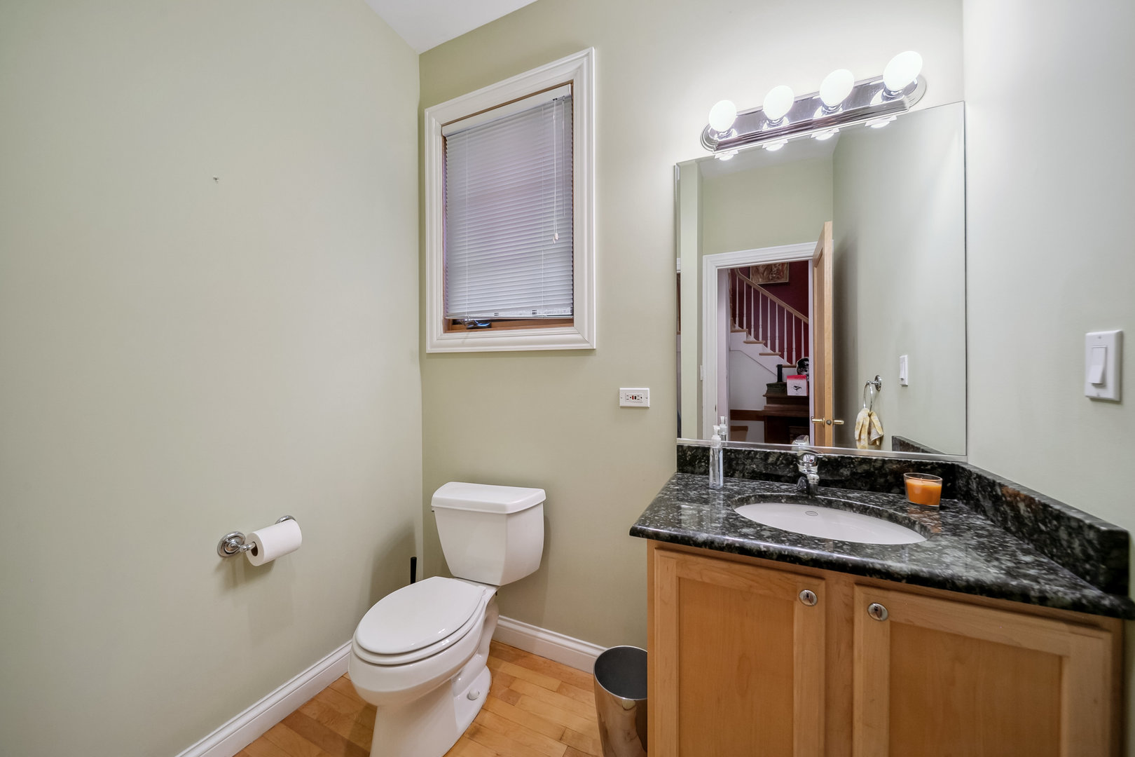 Undisclosed Address Park Ridge, IL 60068 - Photo 35 of 47 a bathroom with a granite countertop toilet sink and mirror