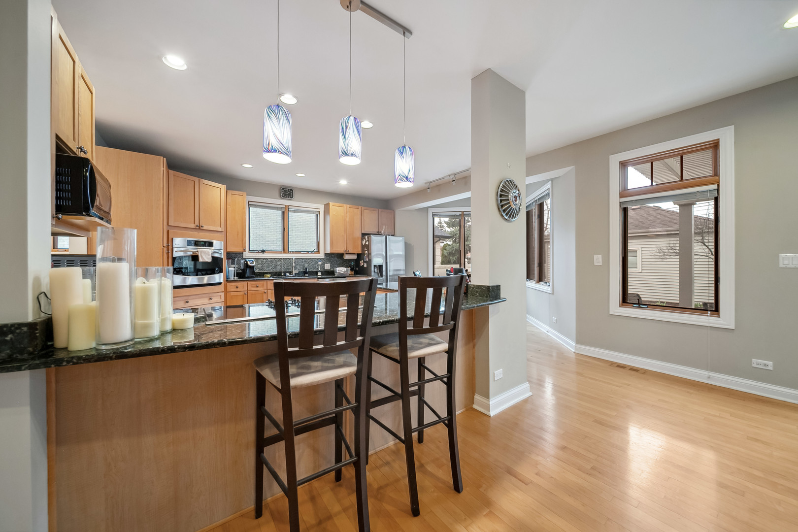 Undisclosed Address Park Ridge, IL 60068 - Photo 7 of 47 a kitchen with stainless steel appliances granite countertop dining table chairs refrigerator and sink
