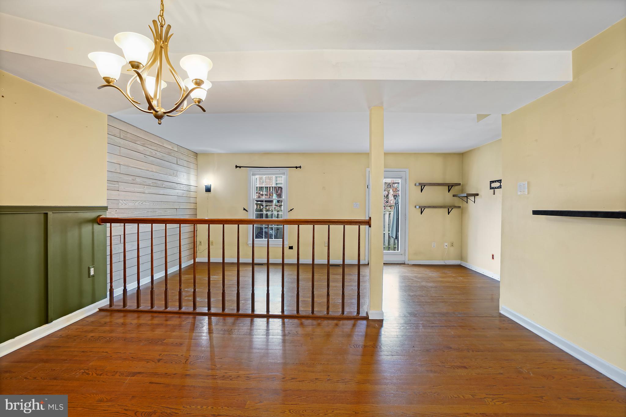 7994 Windsail Court Frederick, MD 21701 - Photo 12 of 46 a view of a hallway with wooden floor and a chandelier