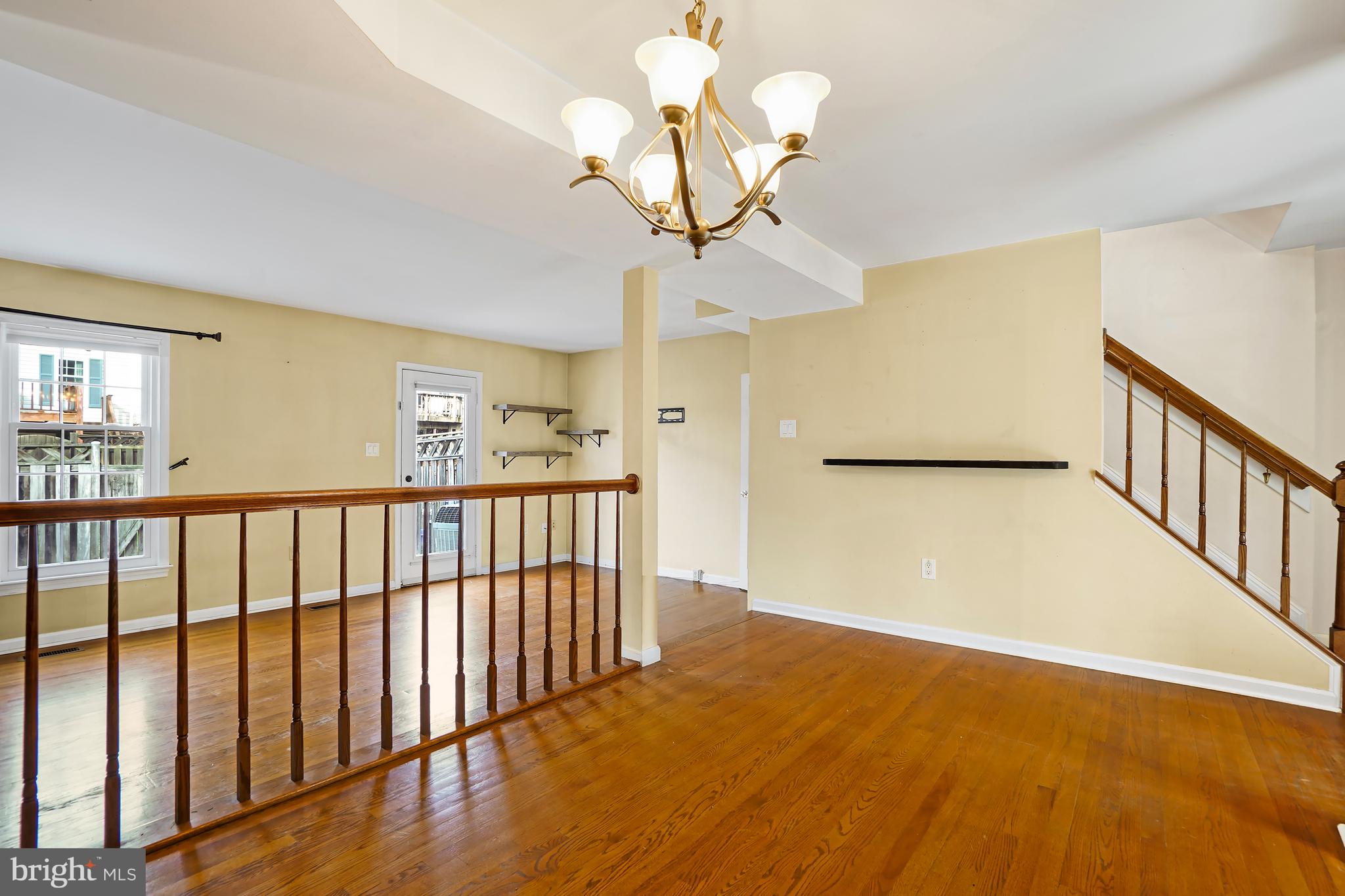 7994 Windsail Court Frederick, MD 21701 - Photo 14 of 46 a view of a hallway with wooden floor and chandelier