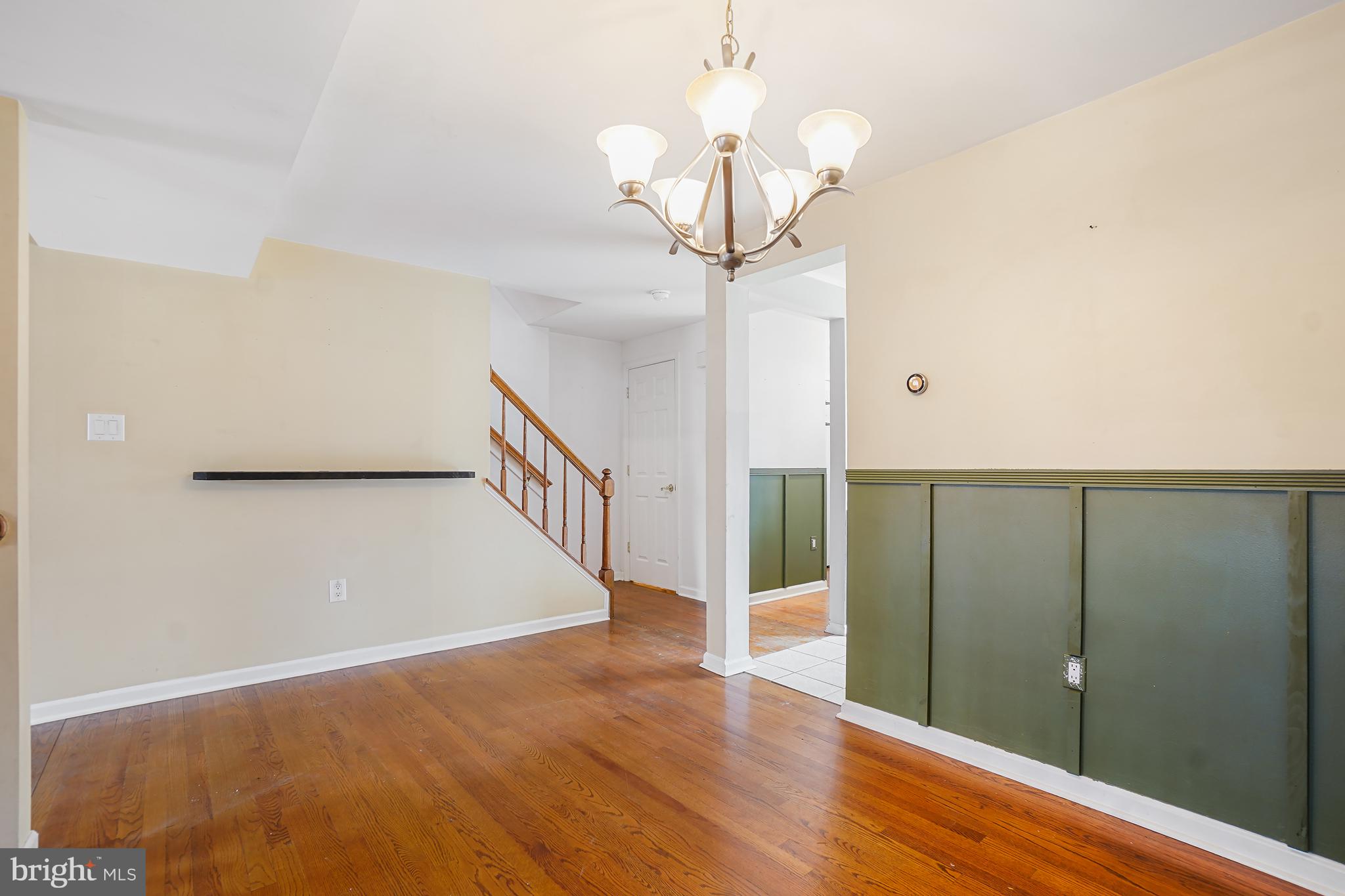 7994 Windsail Court Frederick, MD 21701 - Photo 15 of 46 a view of a hallway with wooden floor and chandelier