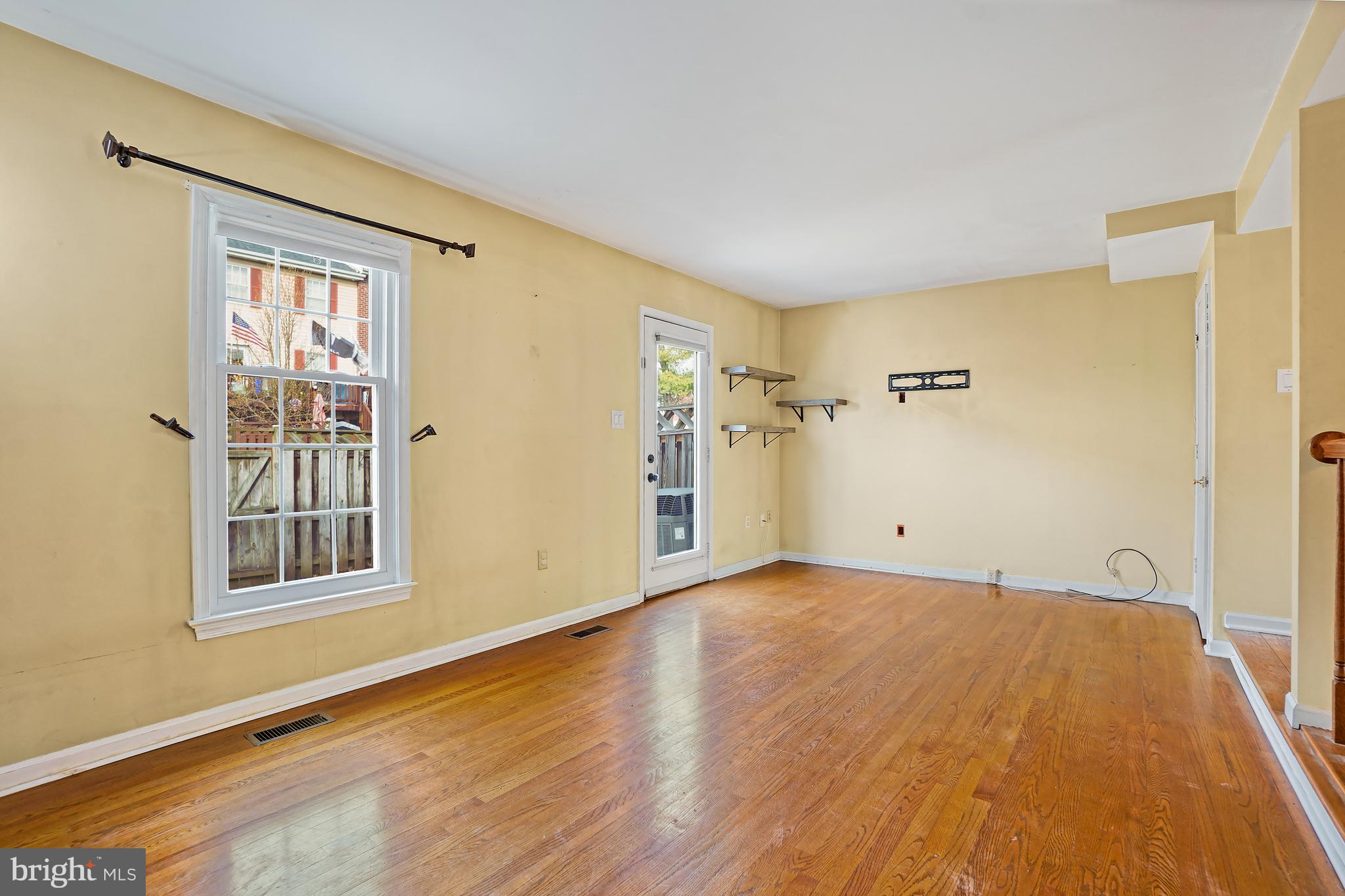 7994 Windsail Court Frederick, MD 21701 - Photo 18 of 46 a view of a big room with wooden floor and windows