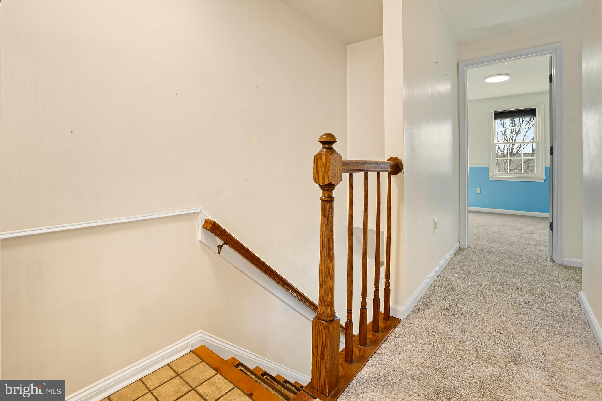 7994 Windsail Court Frederick, MD 21701 - Photo 22 of 46 a view of a hallway with wooden floor and staircase