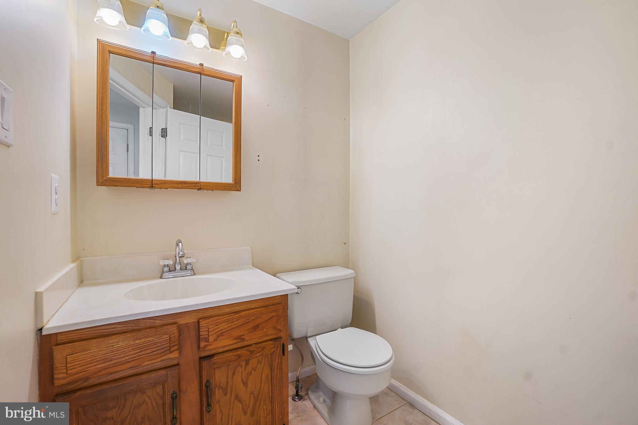 7994 Windsail Court Frederick, MD 21701 - Photo 28 of 46 a bathroom with a sink mirror and toilet