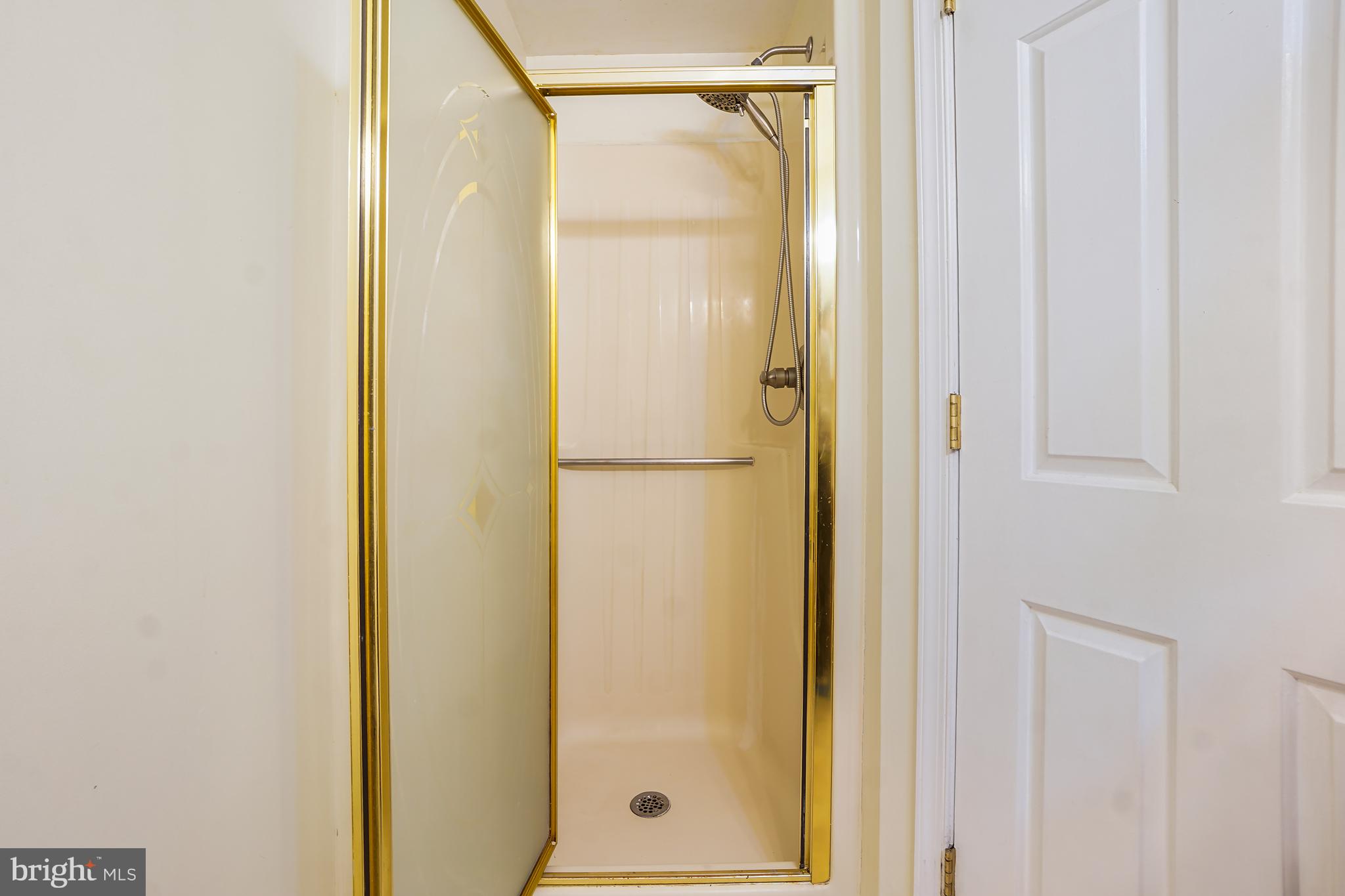 7994 Windsail Court Frederick, MD 21701 - Photo 29 of 46 a bathroom with a glass shower door