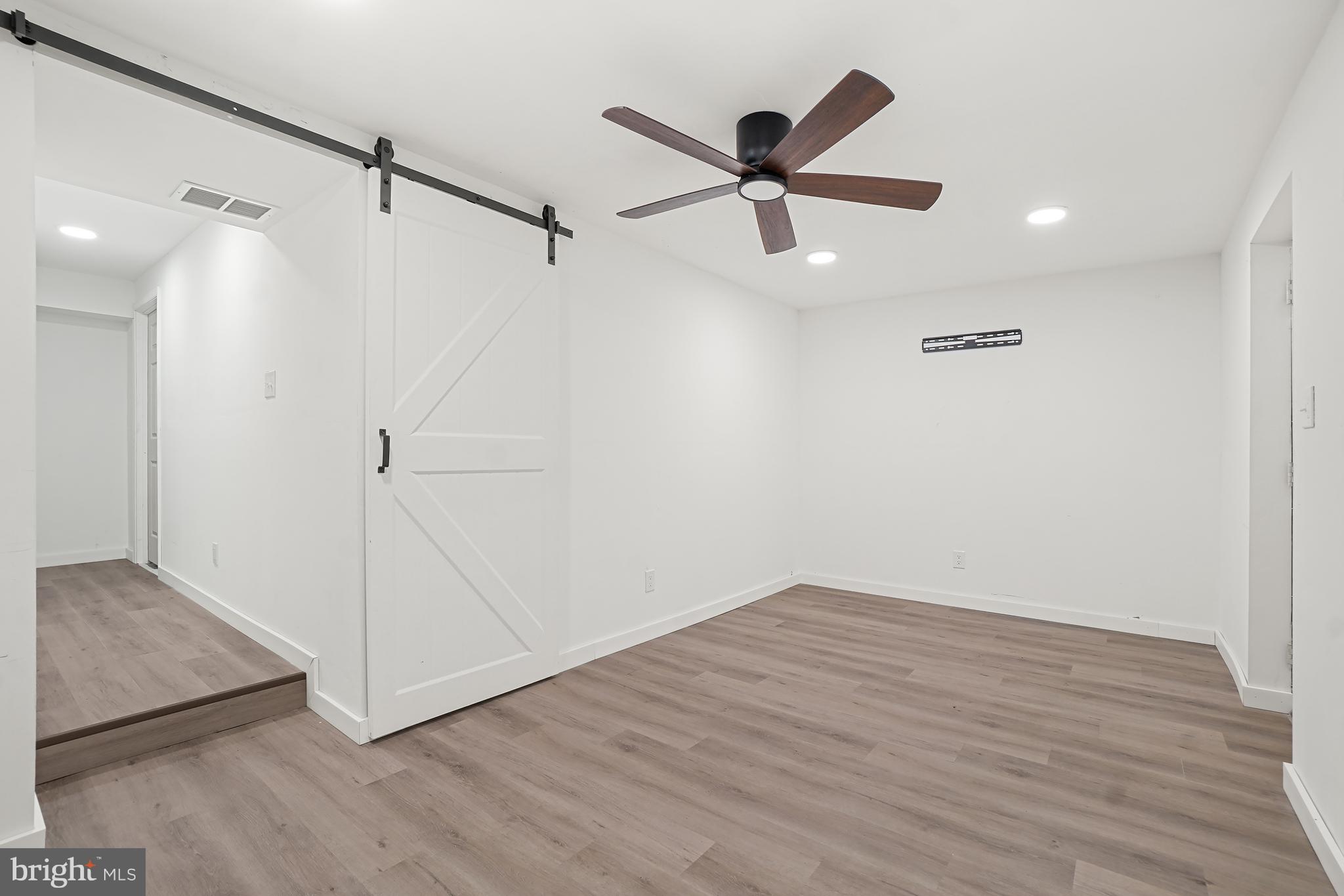 7994 Windsail Court Frederick, MD 21701 - Photo 38 of 46 a view of a big room with wooden floor and windows
