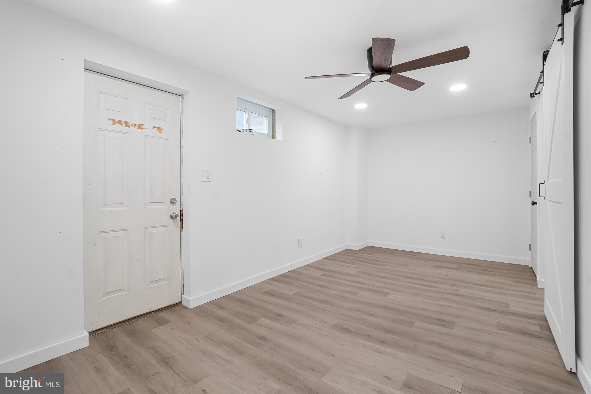 7994 Windsail Court Frederick, MD 21701 - Photo 39 of 46 an empty room with wooden floor cabinet and a ceiling fan