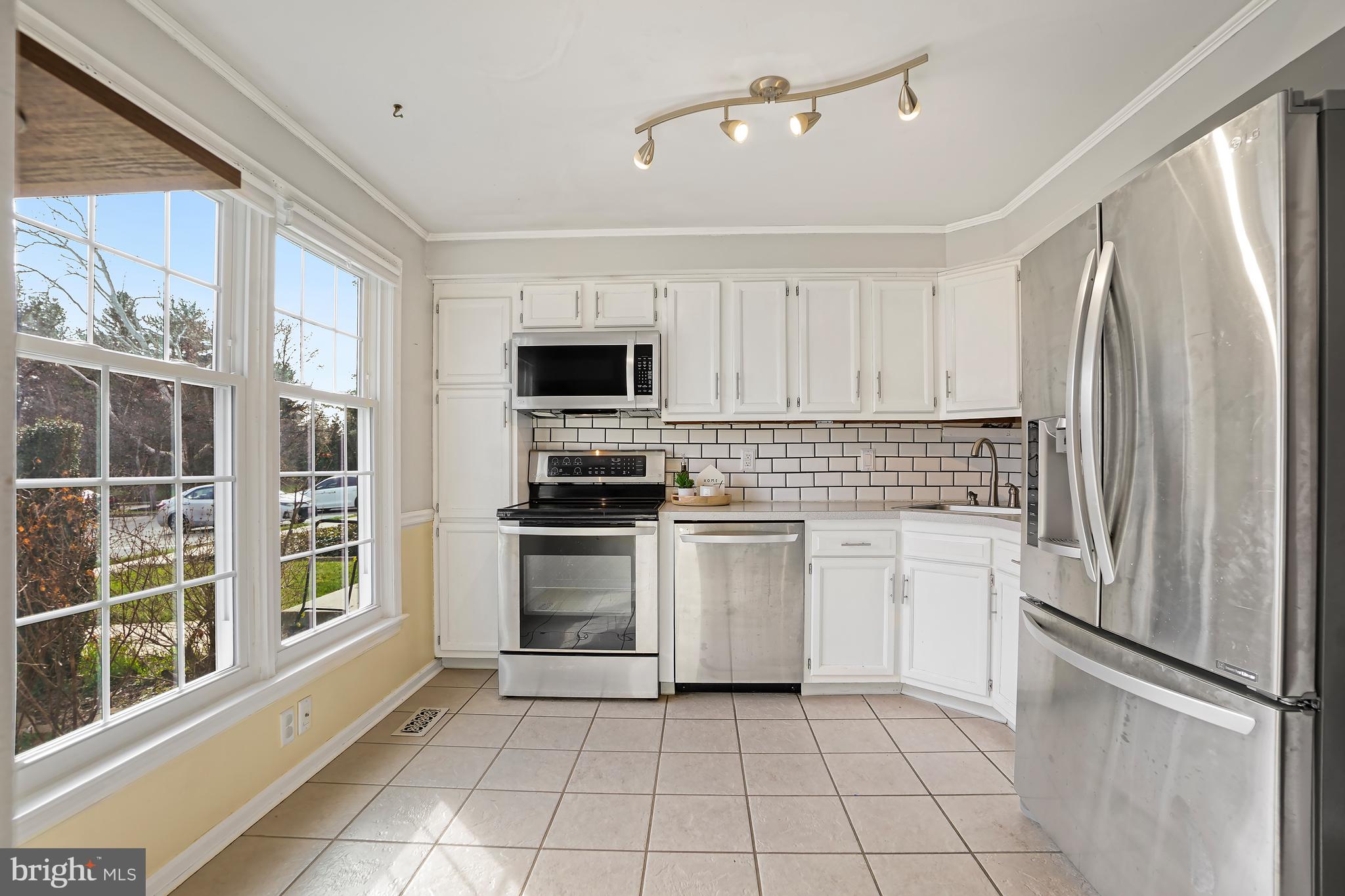 7994 Windsail Court Frederick, MD 21701 - Photo 4 of 46 a kitchen with stainless steel appliances a refrigerator sink and microwave