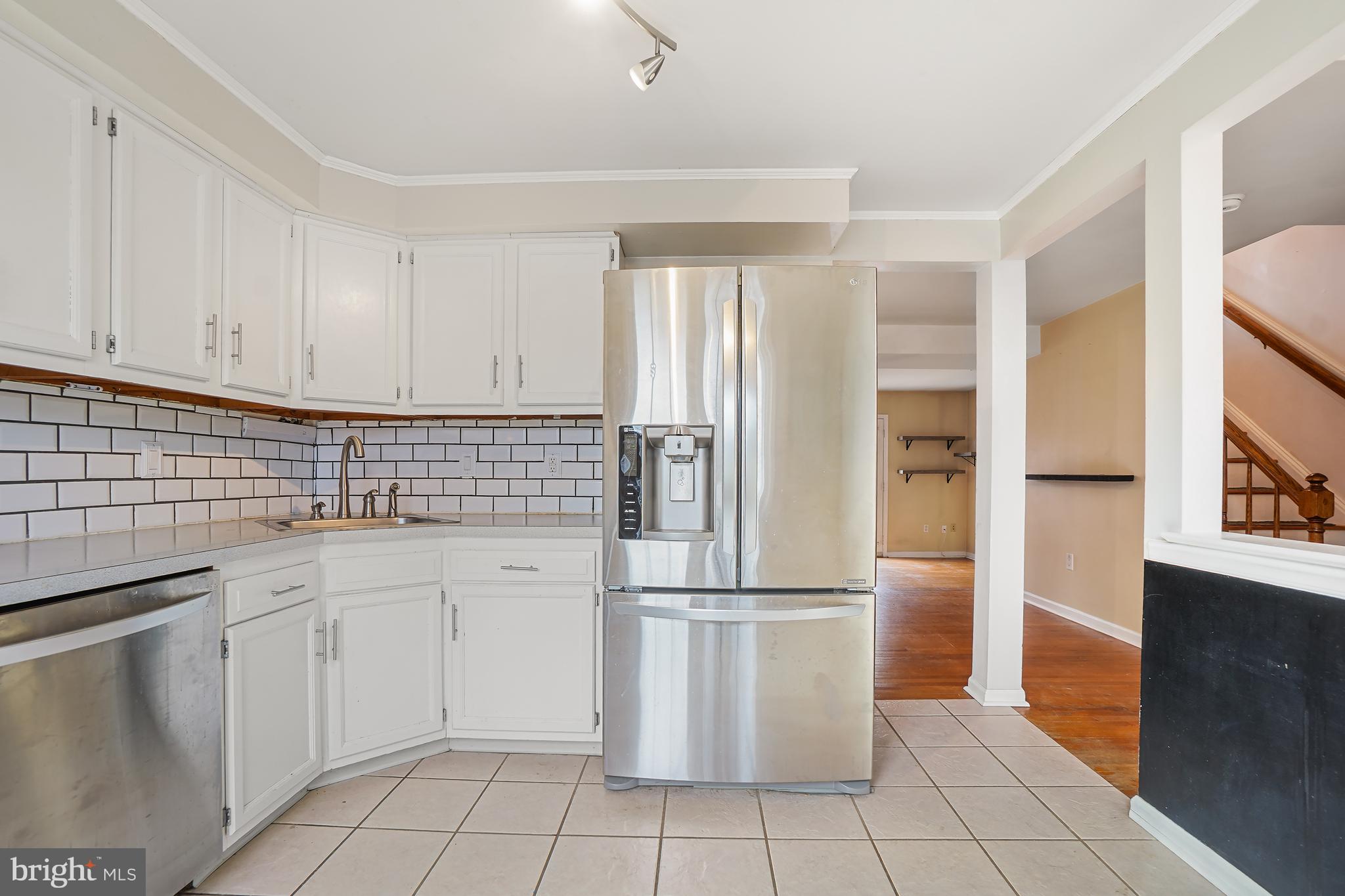 7994 Windsail Court Frederick, MD 21701 - Photo 6 of 46 a kitchen with white cabinets a sink and appliances
