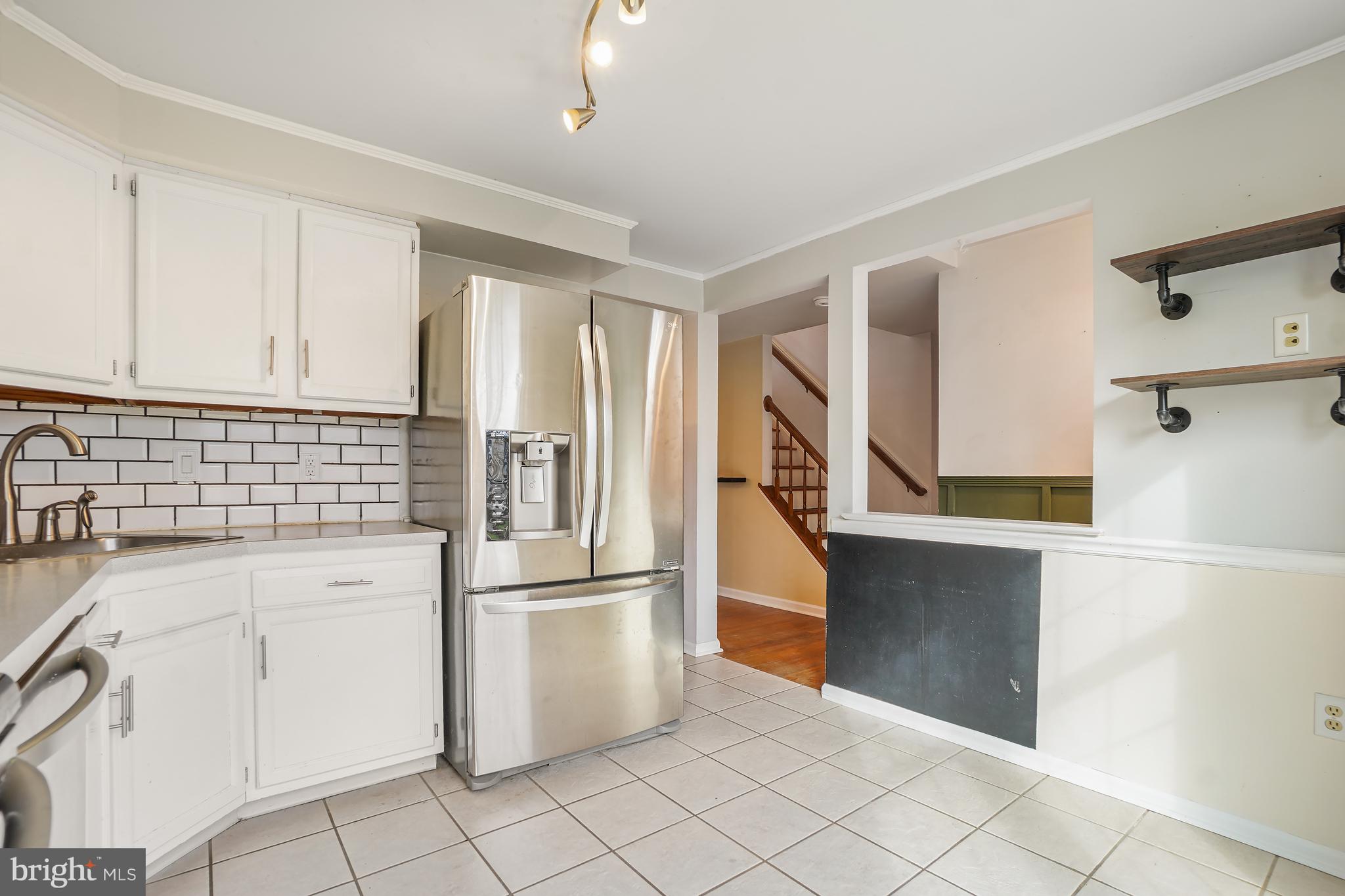 7994 Windsail Court Frederick, MD 21701 - Photo 7 of 46 a kitchen with white cabinets and stainless steel appliances