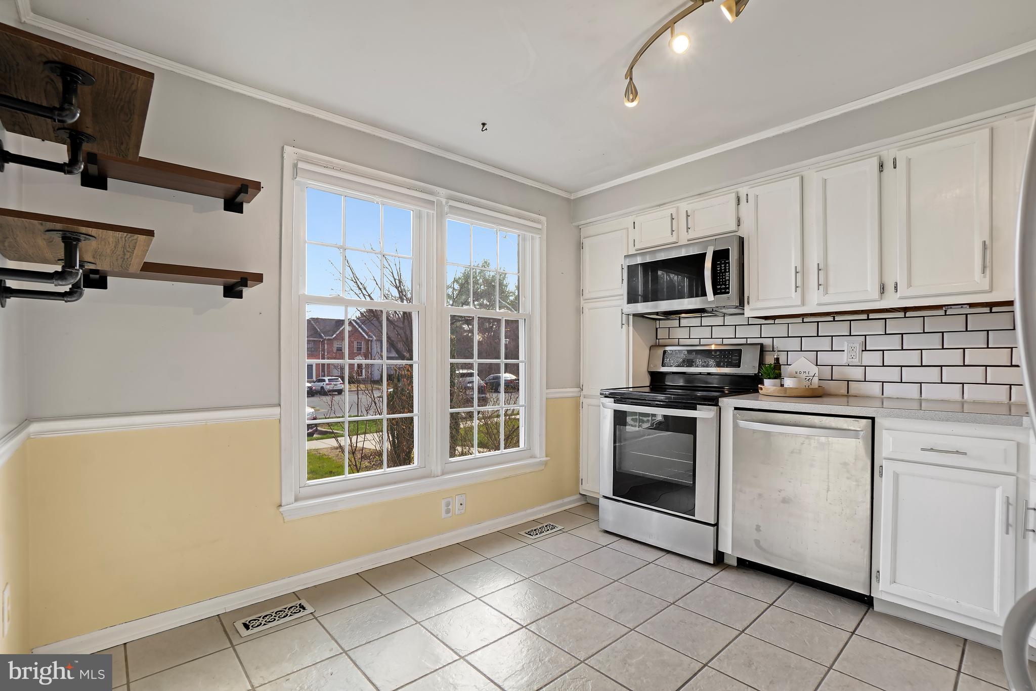 7994 Windsail Court Frederick, MD 21701 - Photo 8 of 46 a kitchen with stainless steel appliances granite countertop a stove a sink and a microwave
