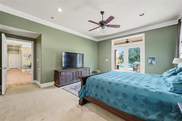 a bedroom with a bed mirror and a window