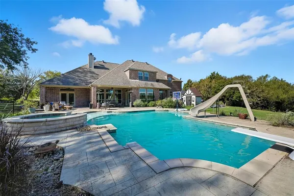 a view of a patio with dining table and chairs