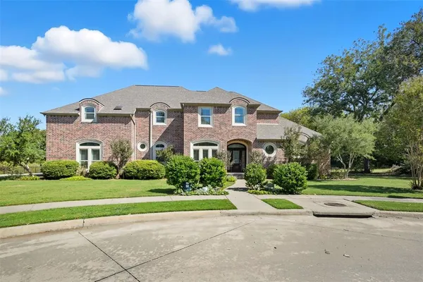 a front view of building with yard and green space