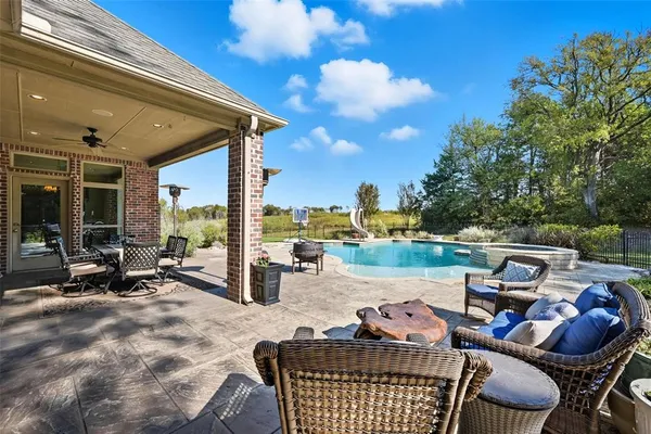 a view of a patio with a table and chairs