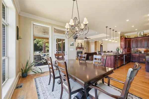 a kitchen with stainless steel appliances granite countertop a refrigerator a stove and a wooden floors