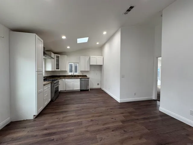 a view of kitchen with cabinets and wooden floor