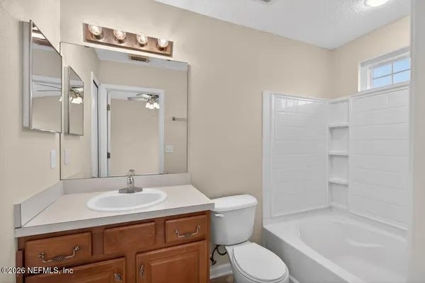 a bathroom with a sink toilet and a mirror