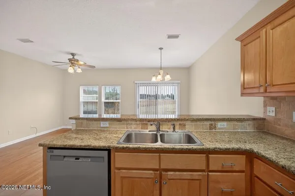 a kitchen with stainless steel appliances granite countertop a refrigerator stove and microwave