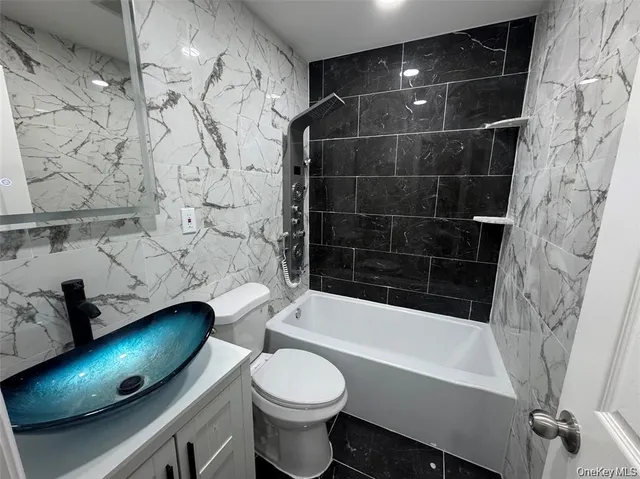 a bathroom with a bathtub toilet and sink