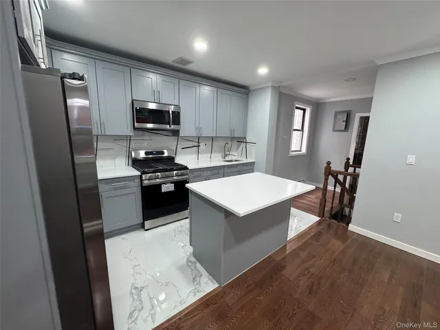 a kitchen with a refrigerator sink and microwave