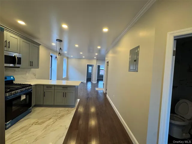 a large kitchen with a sink and dishwasher stove top oven