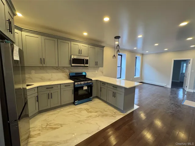 a kitchen with a refrigerator sink and wooden cabinets