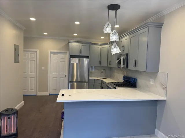 a kitchen with a sink a refrigerator and a stove