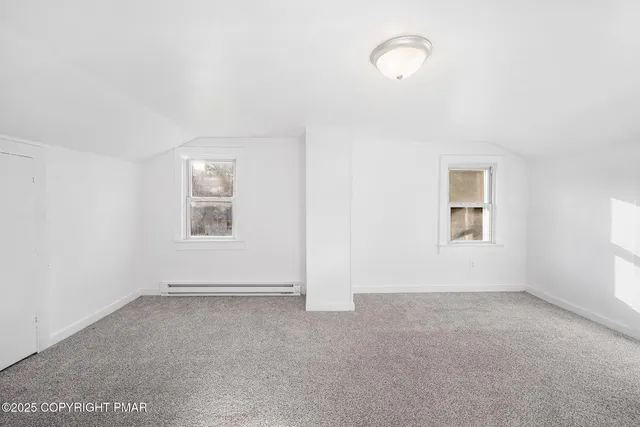 an empty room with a empty space and windows