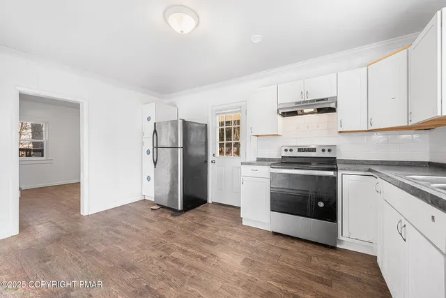 a kitchen with stainless steel appliances a refrigerator stove and microwave