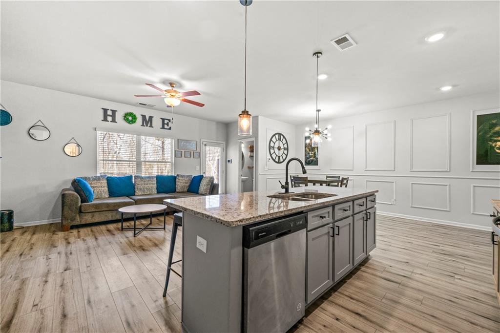 7492 Knoll Hollow Road Lithonia, GA 30058 - Photo 12 of 30 a kitchen with counter top space and wooden floor