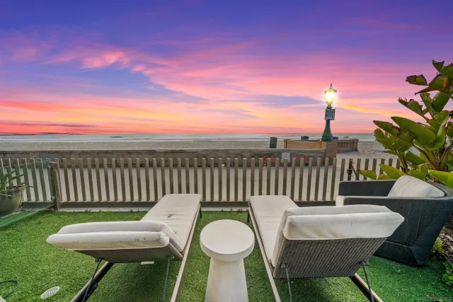 a view of a chairs and table in the backyard