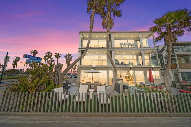 a front view of a building with a garden
