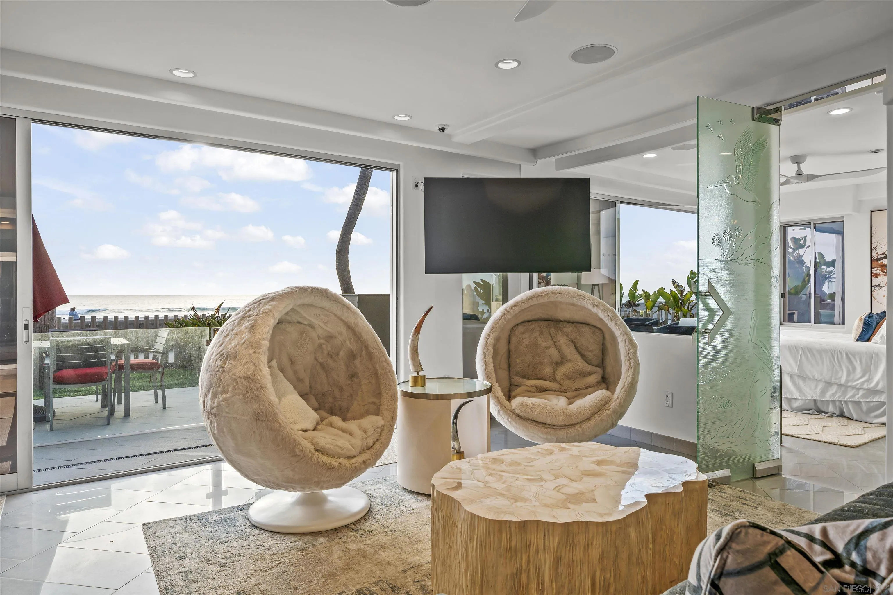 2999 Ocean Front Walk, Unit 1 San Diego, CA 92109 - Photo 2 of 37 a living room with furniture a rug and a floor to ceiling window