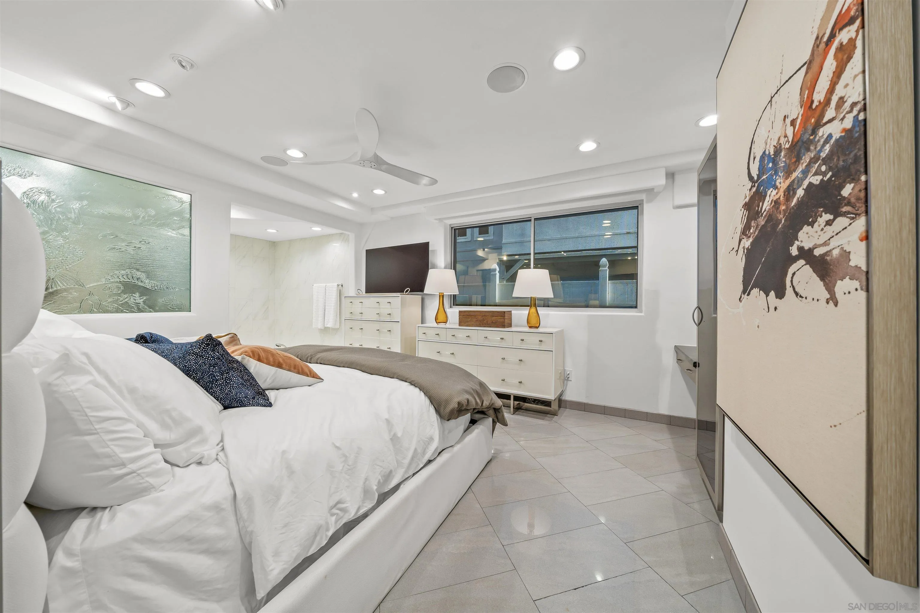 2999 Ocean Front Walk, Unit 1 San Diego, CA 92109 - Photo 22 of 37 a large bedroom with a bed and wooden floor