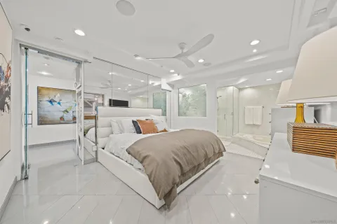a large bedroom with a bed and glass door