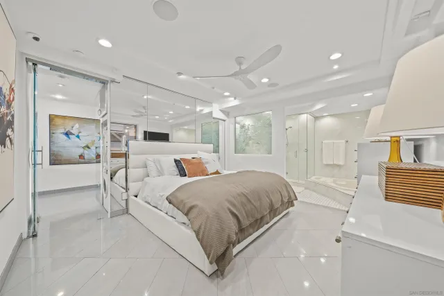 a large bedroom with a bed and glass door